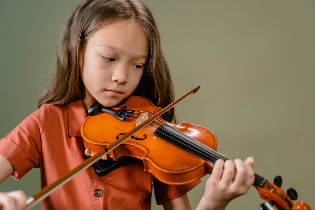 Girl playing violin lamenting the high cost of living in New Jersey, possibly.